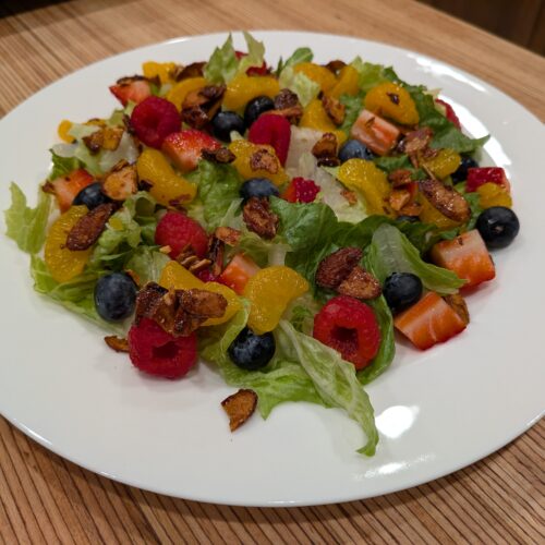 Crunchy lettuce topped with sweet and tangy berries mixed with mandarin oranges, and some candied almonds.