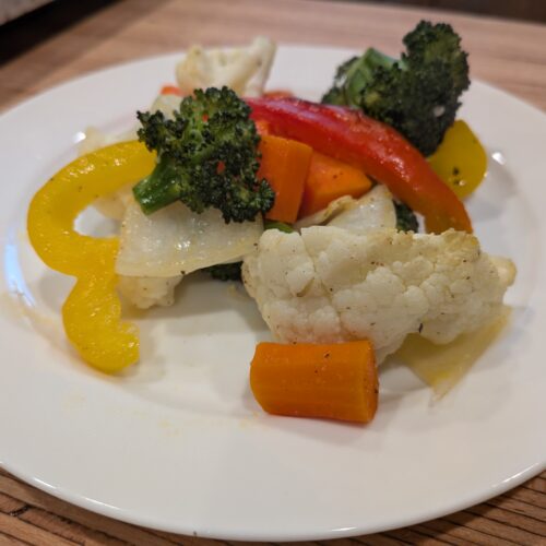 Oven Roasted Veggies Colorful Veggies coated with oil, salt, pepper, and sprinkled with garlic salt. Roasted in the oven until tender and golden with a slight crisp.