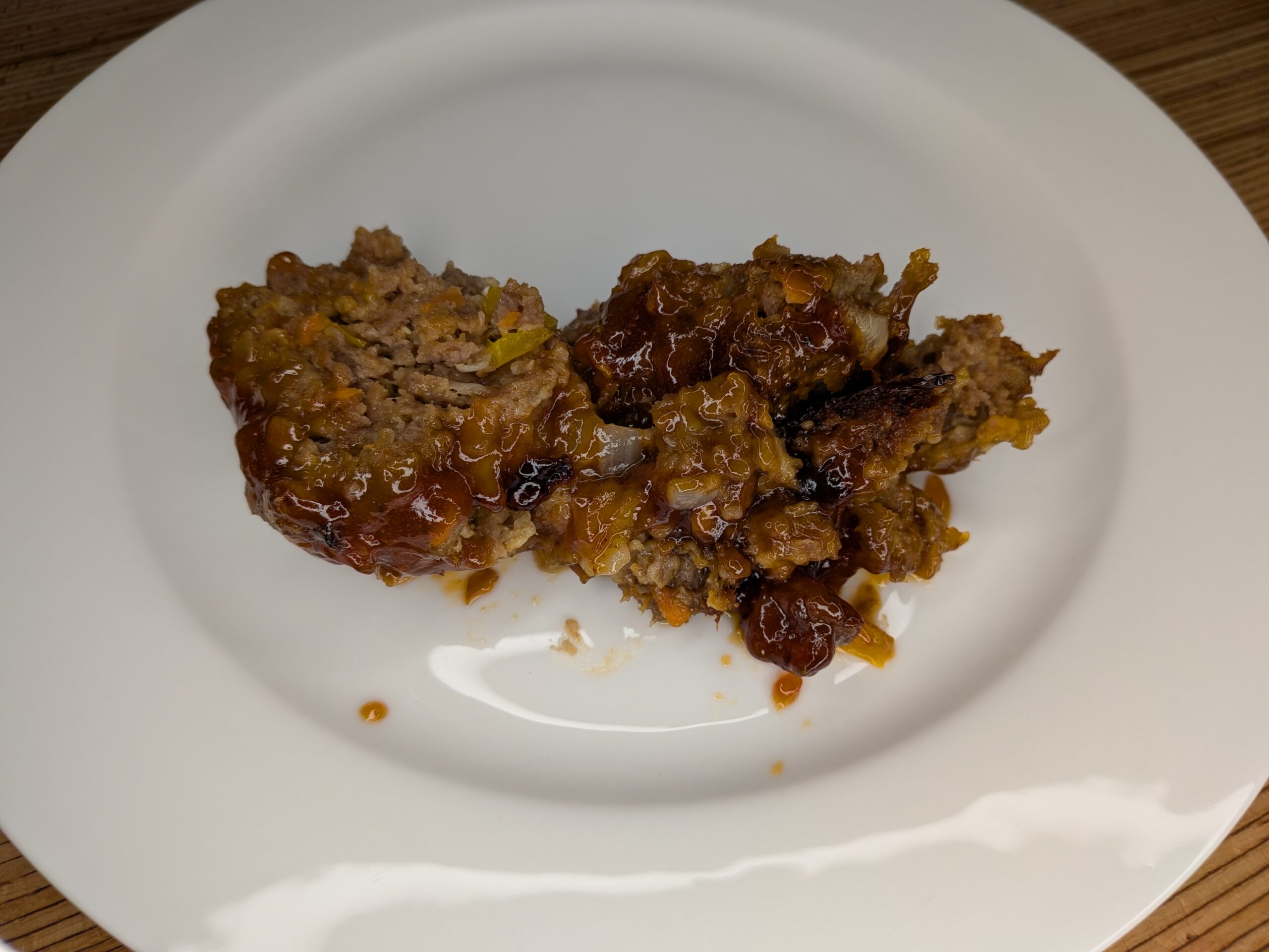 This homemade meatloaf recipe is tender, flavorful, and topped with a sweet and tangy glaze made from ketchup, brown sugar, and mustard. Made with ground beef, onions, bell peppers, and oatmeal.